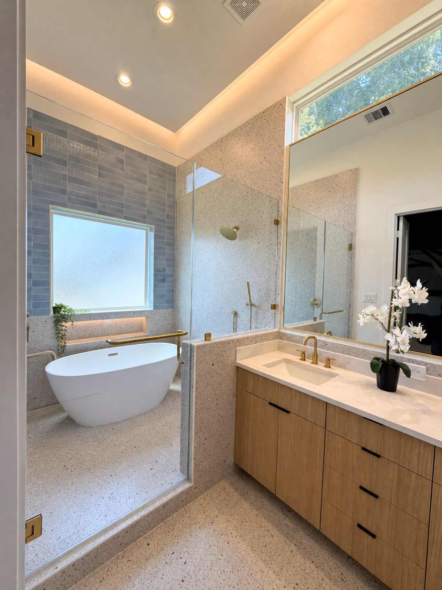 Spa-style master bath with frameless shower and freestanding tub