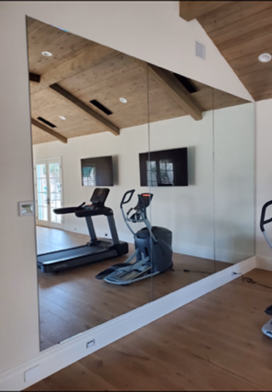 Full-wall gym mirror installation