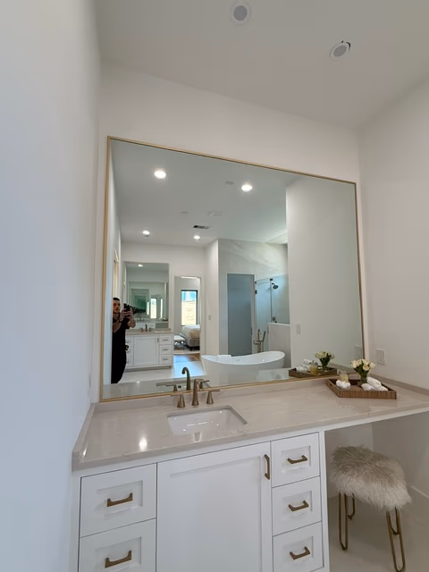 Custom-framed vanity mirror in primary bath