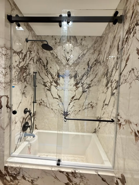 Marble shower with matte-black sliding hardware