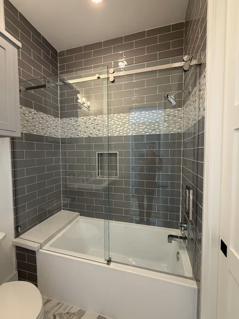 Sliding glass shower over tub with subway tile