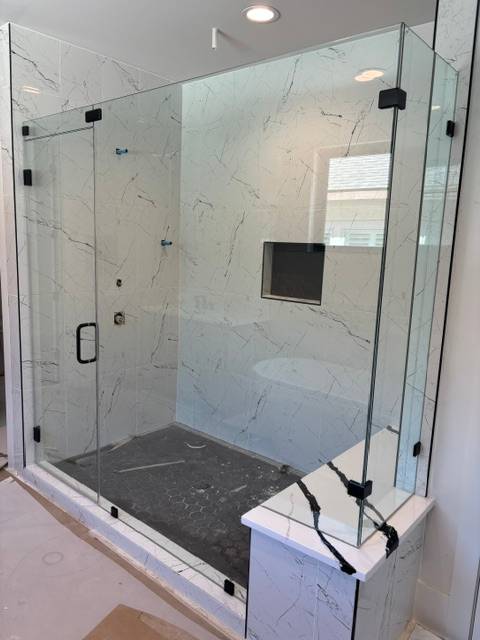 Frameless walk-in shower with marble surround